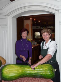 Hanni Silberberger (Hotel Alte Post) und Elisabeth Kammerlander (Hotel Schachtner) beim Anschneiden des ersteigerten Riesenherbsttanzlkürbis